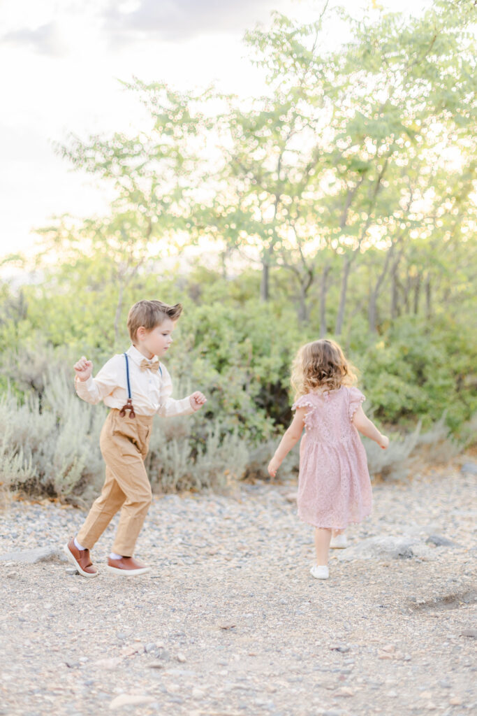 Candid moment of kids playing with siblings during a family session in Alpine Utah, photographed by a Provo Utah photographer.