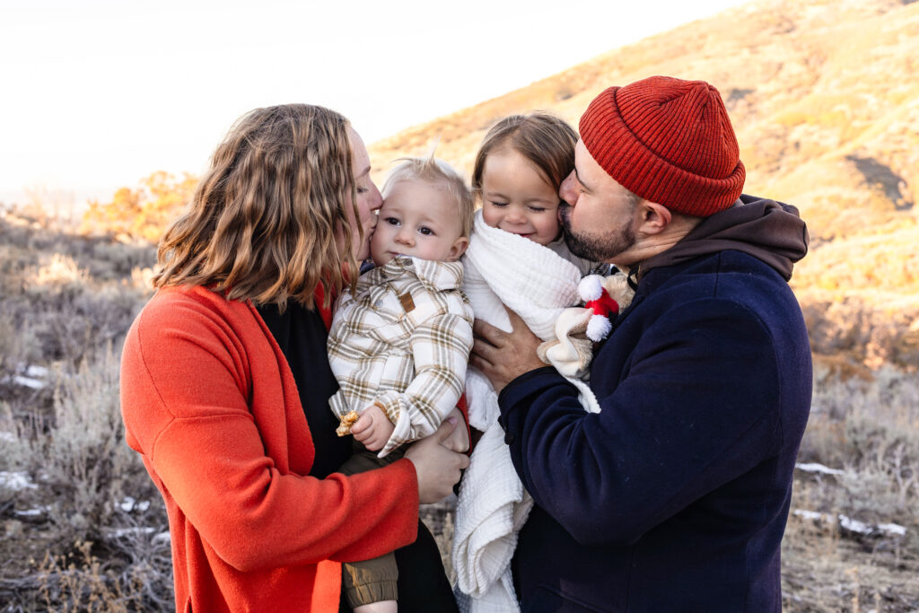 An outdoor fall family portrait set among golden autumn foliage, capturing a family together in warm, coordinated outfits. Rich fall colors, soft consistent light, and natural movement create a cozy, timeless image that highlights connection, comfort, and seasonal beauty.